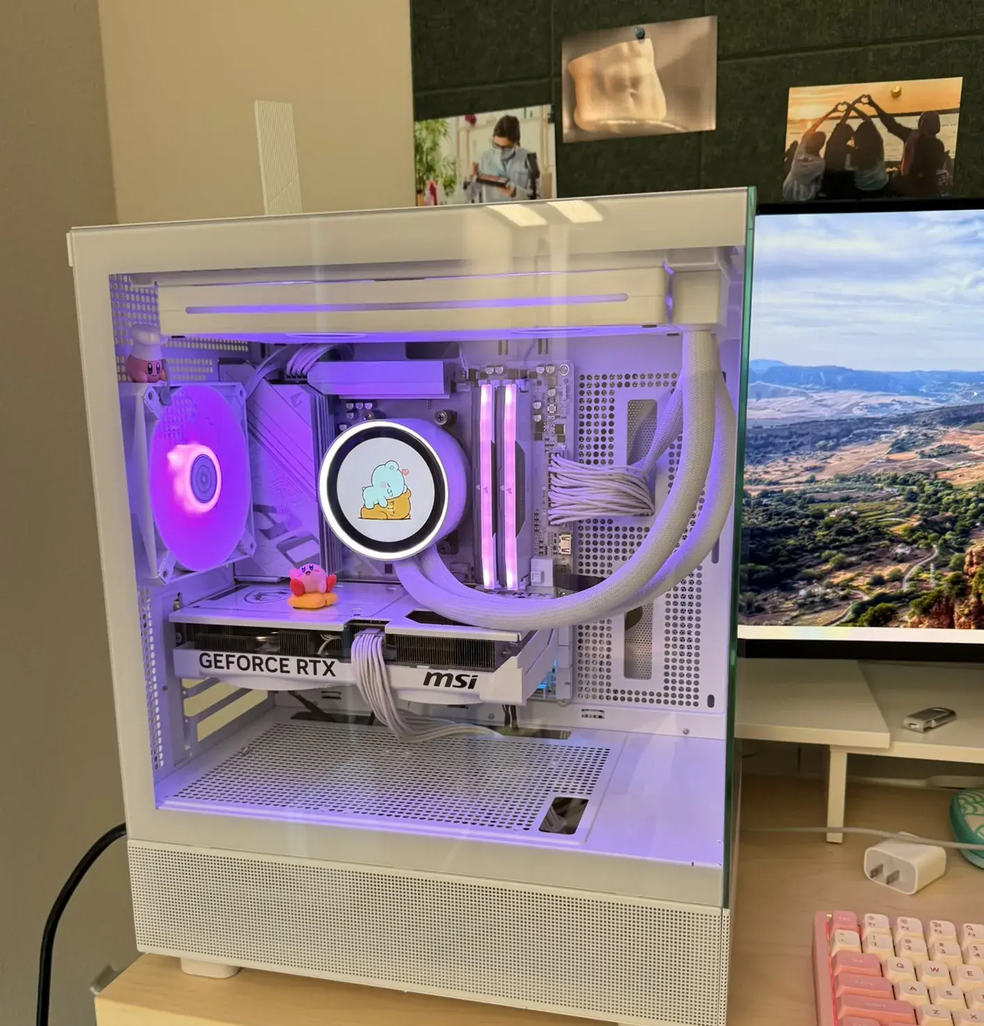 Kimberly's white PC through its glass, lit pink and purple, a Kirby riding his Warp Star on the graphics card.