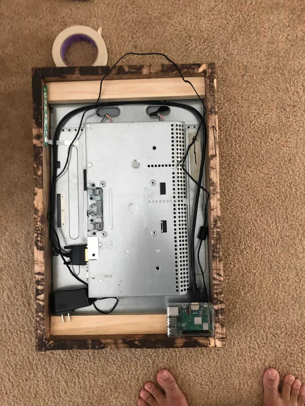 The back of the mirror: the monitor's insides and the Raspberry Pi, fitted in the frame.