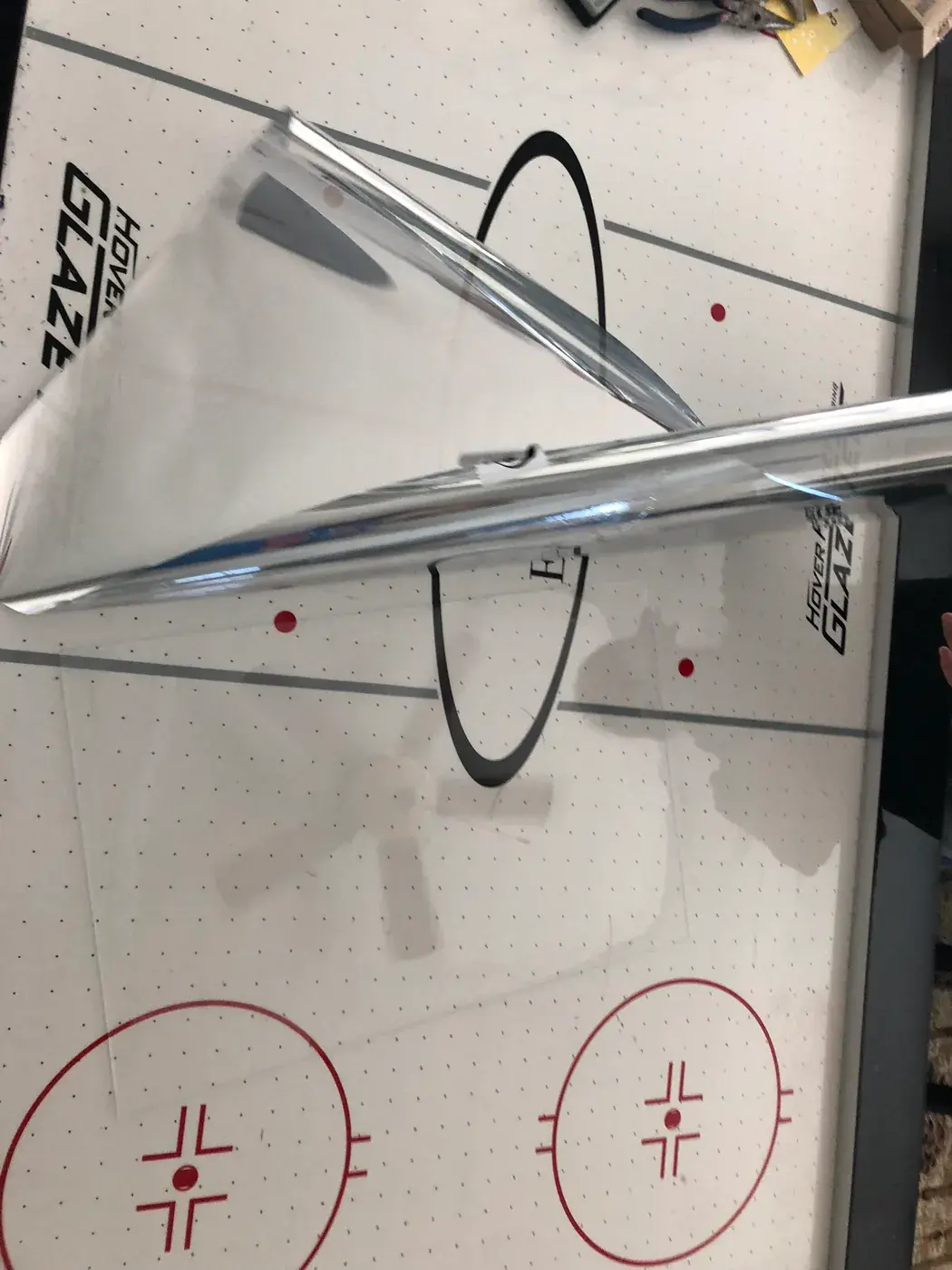Peeling the film off the two-way glass.